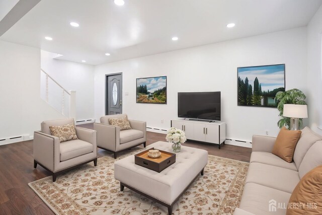 living room featuring stairway, recessed lighting, a baseboard heating unit, and wood finished floors