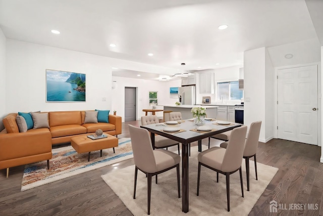 dining area with dark wood-style floors and recessed lighting