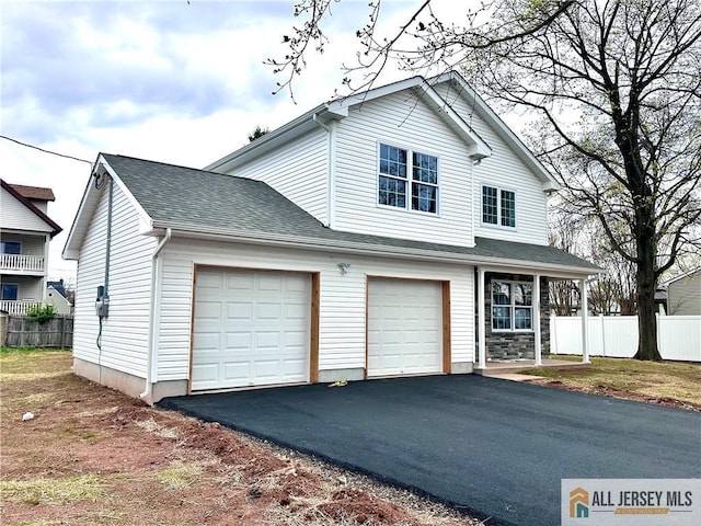 101 S Dover Ave, Franklin, NJ 08873 - view of front of home featuring asphalt driveway, an attached garage, and a shingled roof