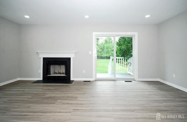 54 Castle Pointe Blvd, Piscataway, NJ 08854 - unfurnished living room with wood finished floors, baseboards, a fireplace, and recessed lighting