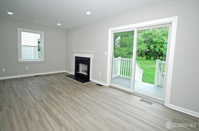 54 Castle Pointe Blvd, Piscataway, NJ 08854 - unfurnished living room with wood finished floors, a fireplace with flush hearth, baseboards, and recessed lighting