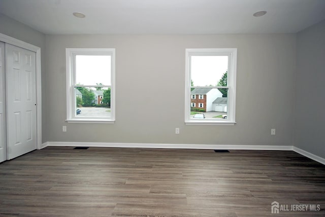 54 Castle Pointe Blvd, Piscataway, NJ 08854 - unfurnished bedroom featuring multiple windows, baseboards, and wood finished floors