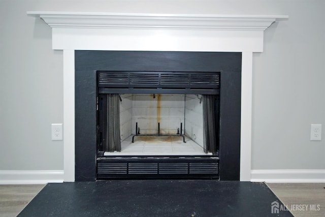54 Castle Pointe Blvd, Piscataway, NJ 08854 - detailed view of a fireplace with flush hearth, baseboards, and wood finished floors