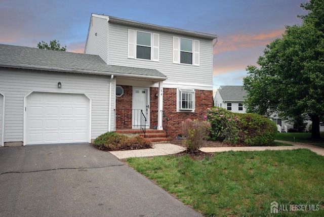 54 Castle Pointe Blvd, Piscataway, NJ 08854 - view of front facade with a garage, driveway, brick siding, and a yard