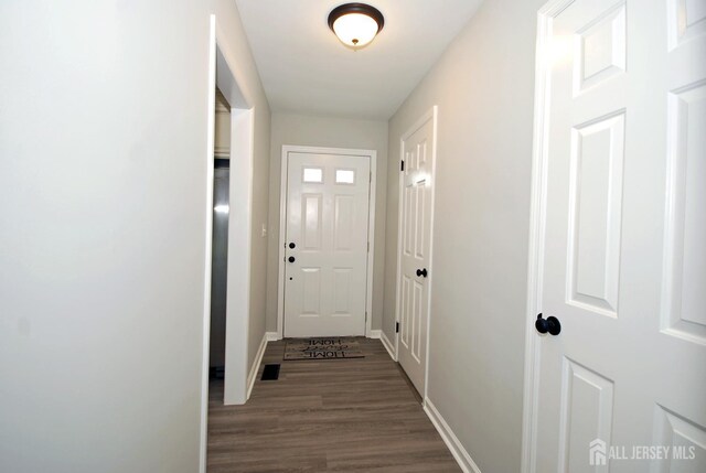 54 Castle Pointe Blvd, Piscataway, NJ 08854 - doorway featuring dark wood-style floors and baseboards