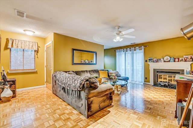 living area featuring plenty of natural light, baseboards, and a fireplace with flush hearth