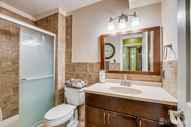 full bath featuring toilet, tile walls, a shower stall, and vanity