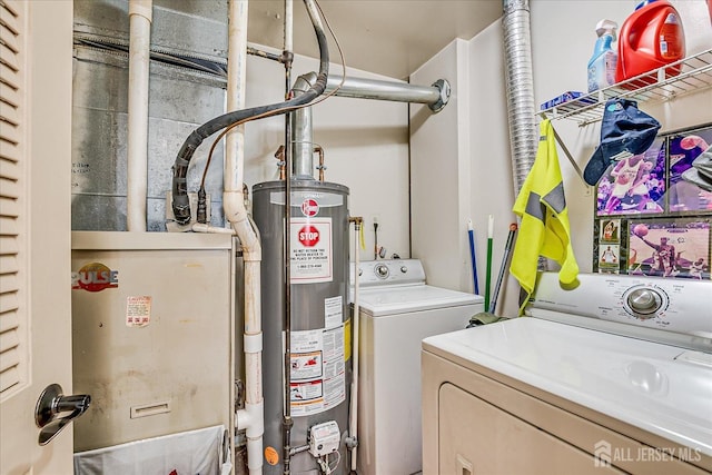 laundry area with laundry area, washer and clothes dryer, and gas water heater