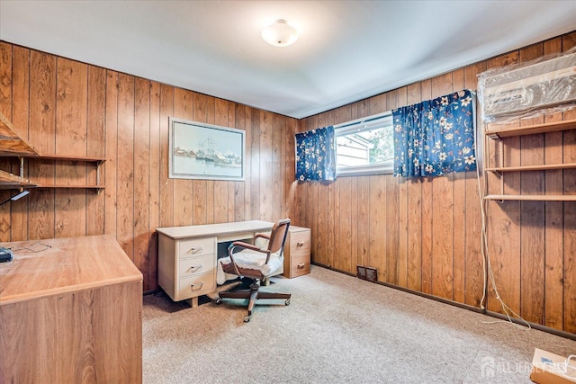 carpeted office space with wood walls