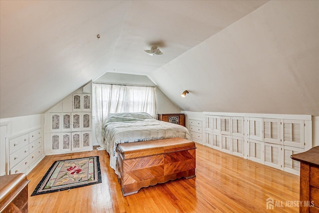 bedroom featuring wood finished floors and vaulted ceiling