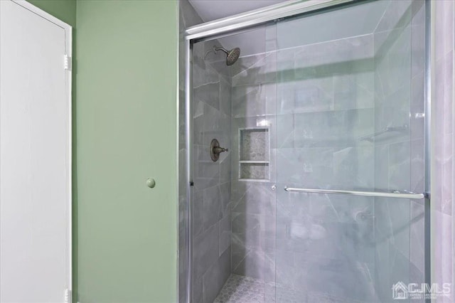 bathroom with a shower with shower door