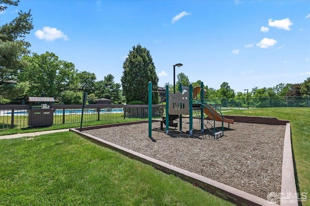 view of playground with a lawn