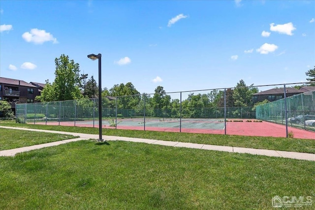 view of sport court featuring a lawn