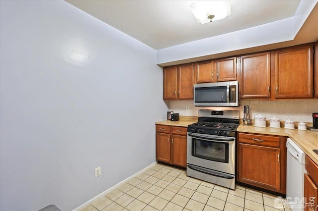 kitchen featuring appliances with stainless steel finishes and light tile patterned floors