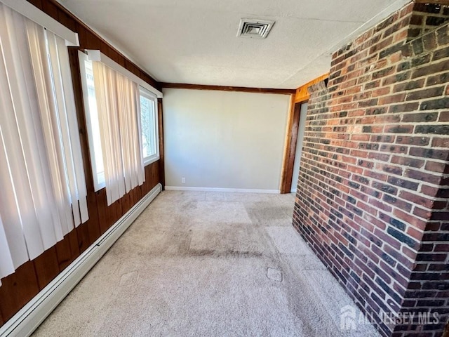 130 Maple Pl S, Plainfield, NJ 07080 - unfurnished room featuring baseboard heating, light carpet, brick wall, baseboards, and crown molding