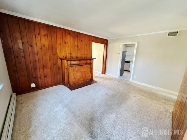 130 Maple Pl S, Plainfield, NJ 07080 - unfurnished living room featuring a baseboard heating unit, ornamental molding, light carpet, baseboards, and wooden walls