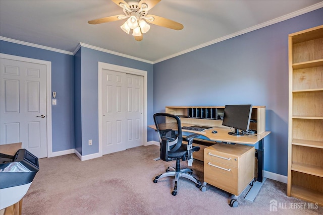 carpeted home office featuring crown molding, baseboards, and ceiling fan
