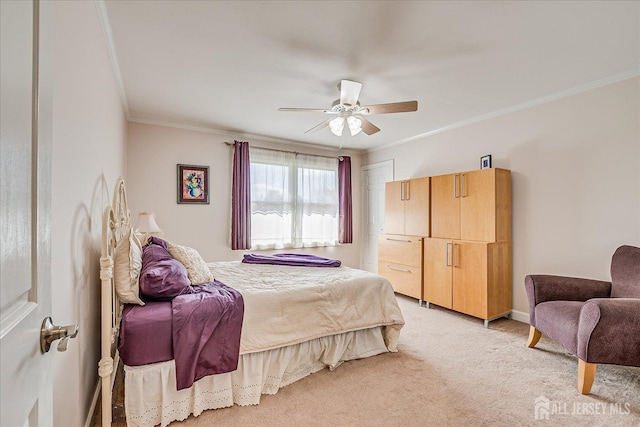 bedroom featuring ornamental molding, ceiling fan, and light colored carpet