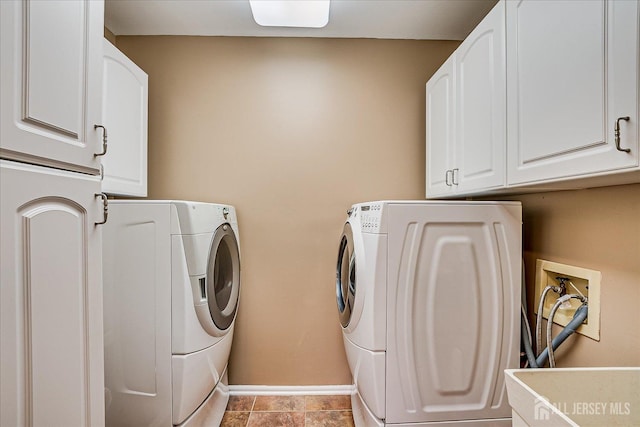 laundry area featuring washer and dryer, baseboards, and cabinet space