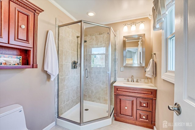full bathroom featuring a shower stall, crown molding, vanity, and toilet