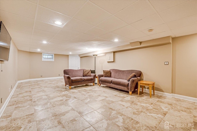 living room featuring recessed lighting, a drop ceiling, and baseboards