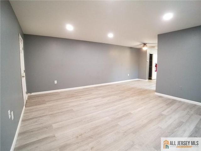 empty room featuring light wood-style floors, baseboards, a ceiling fan, and recessed lighting