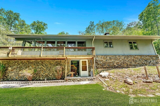 34 Stony Brook Rd, Blairstown, NJ 07825 - view of front facade featuring stone siding, a wooden deck, and a front yard