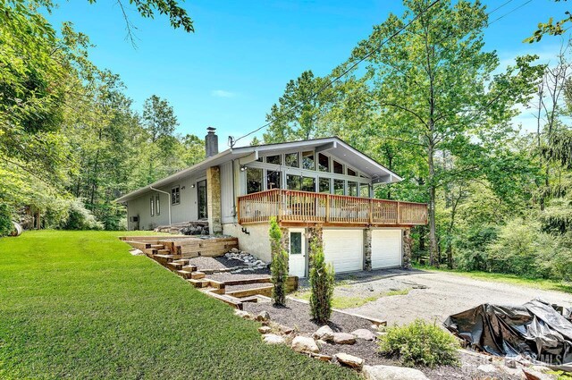 34 Stony Brook Rd, Blairstown, NJ 07825 - view of front of property with a chimney, a front yard, a garage, driveway, and a deck