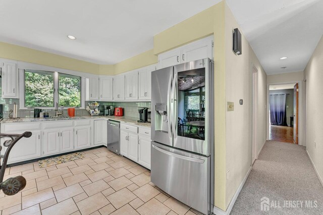 34 Stony Brook Rd, Blairstown, NJ 07825 - kitchen with appliances with stainless steel finishes, white cabinetry, backsplash, light stone counters, and recessed lighting