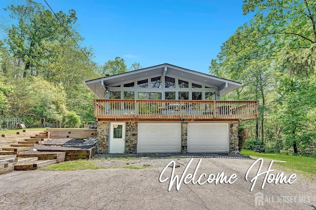 34 Stony Brook Rd, Blairstown, NJ 07825 - chalet / cabin with stone siding, driveway, an attached garage, and a wooden deck