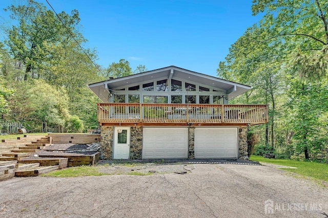 34 Stony Brook Rd, Blairstown, NJ 07825 - view of front facade with stone siding, asphalt driveway, and a deck