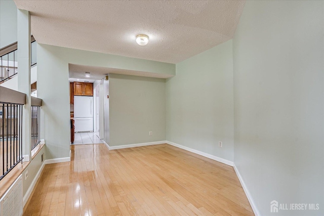 68 Kelly Dr, Edison, NJ 08820 - empty room featuring light wood finished floors and a textured ceiling