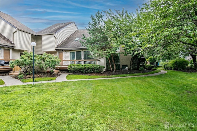 68 Kelly Dr, Edison, NJ 08820 - view of front of property with a wooden deck, a front yard, and a shingled roof