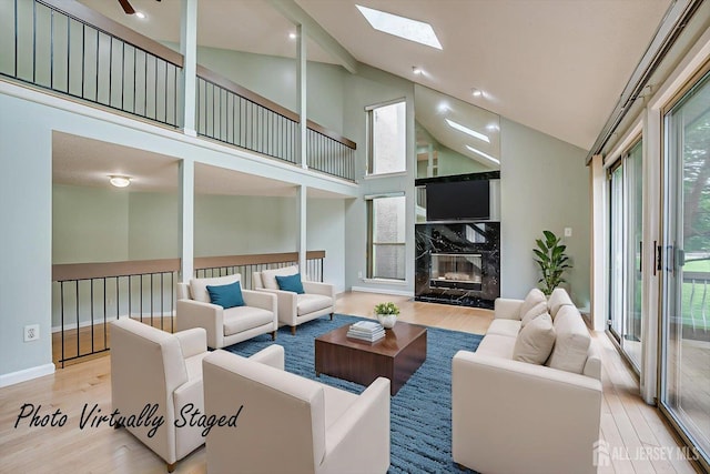 68 Kelly Dr, Edison, NJ 08820 - living area with wood finished floors, a skylight, high vaulted ceiling, and a high end fireplace