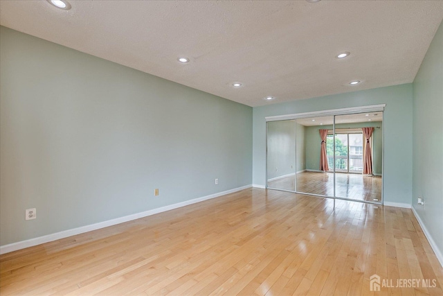 68 Kelly Dr, Edison, NJ 08820 - unfurnished bedroom featuring light wood-type flooring, recessed lighting, a closet, and a textured ceiling