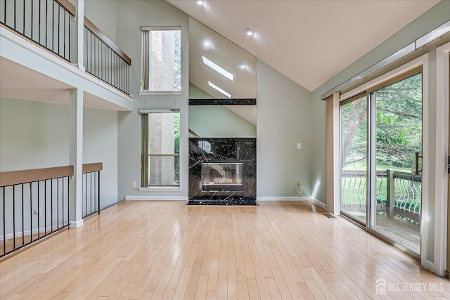 68 Kelly Dr, Edison, NJ 08820 - unfurnished living room featuring high vaulted ceiling, hardwood / wood-style floors, and a high end fireplace