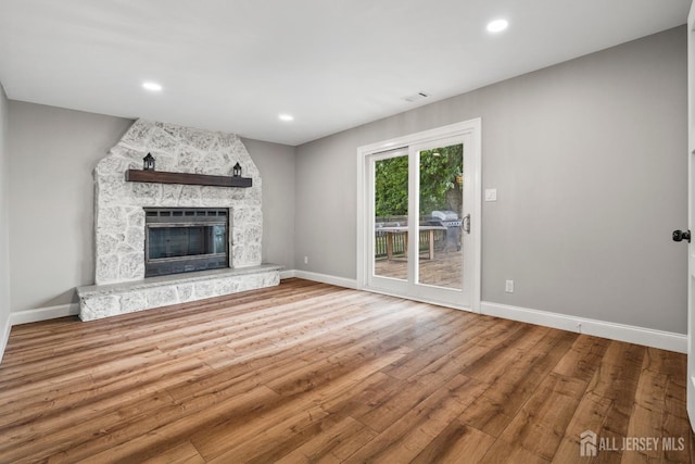 31 Brunswick Dr, Howell, NJ 07731 - unfurnished living room with wood finished floors, a fireplace, and recessed lighting