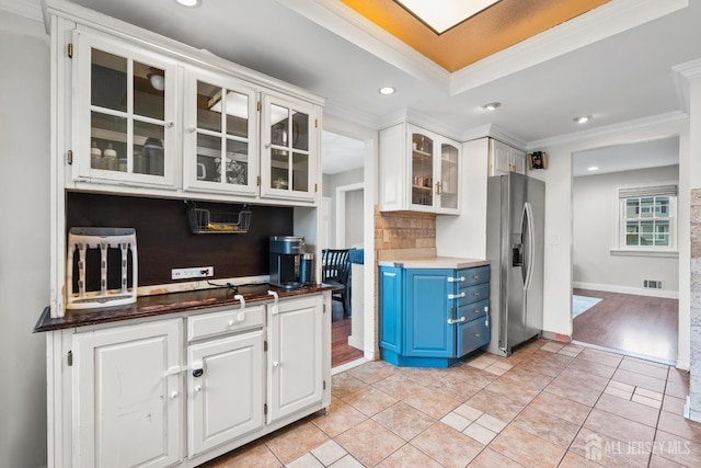 31 Brunswick Dr, Howell, NJ 07731 - kitchen with stainless steel refrigerator with ice dispenser, blue cabinetry, crown molding, white cabinets, and glass insert cabinets