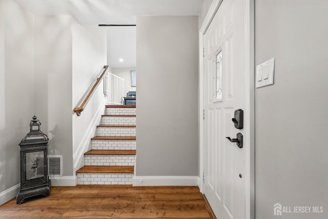 31 Brunswick Dr, Howell, NJ 07731 - stairs with wood finished floors and a wood stove
