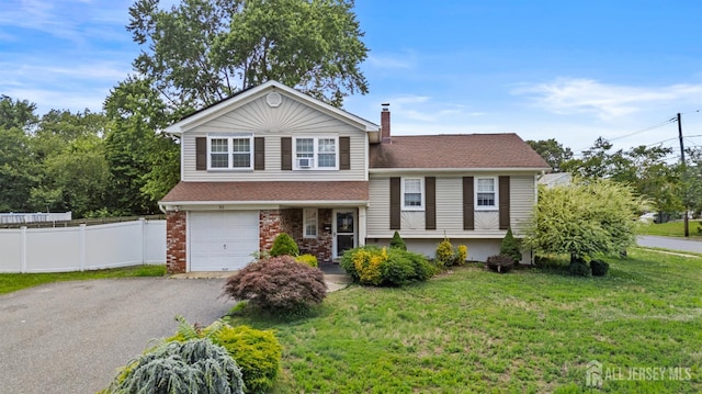 31 Brunswick Dr, Howell, NJ 07731 - tri-level home featuring a garage, driveway, a chimney, roof with shingles, and brick siding