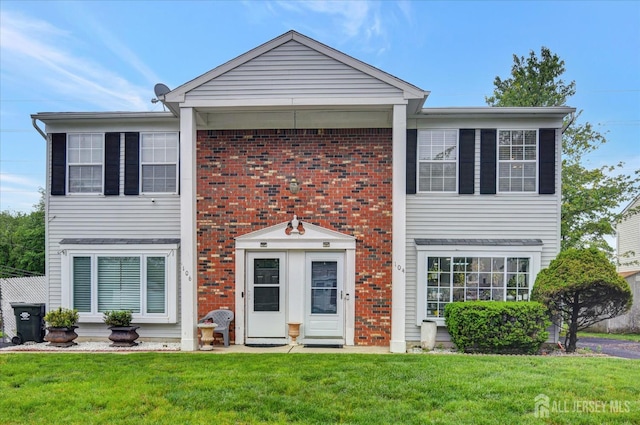 104 Brewster Cir, Old Bridge, NJ 08857 - view of front facade with a front yard and brick siding