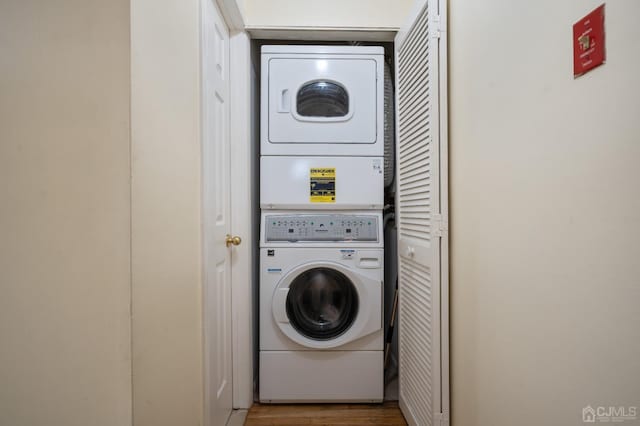 laundry area featuring stacked washing maching and dryer