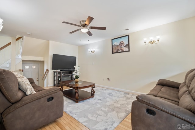 living room with light wood-type flooring and ceiling fan