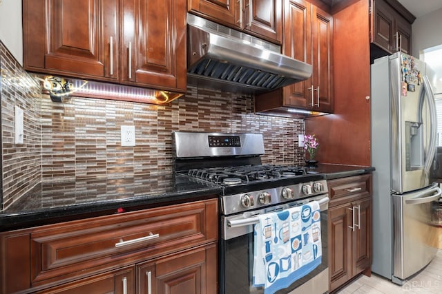 kitchen with stainless steel appliances, dark stone countertops, and decorative backsplash