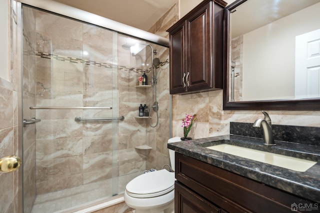 bathroom featuring toilet, vanity, decorative backsplash, and walk in shower