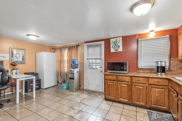 kitchen featuring light stone counters and light tile patterned floors