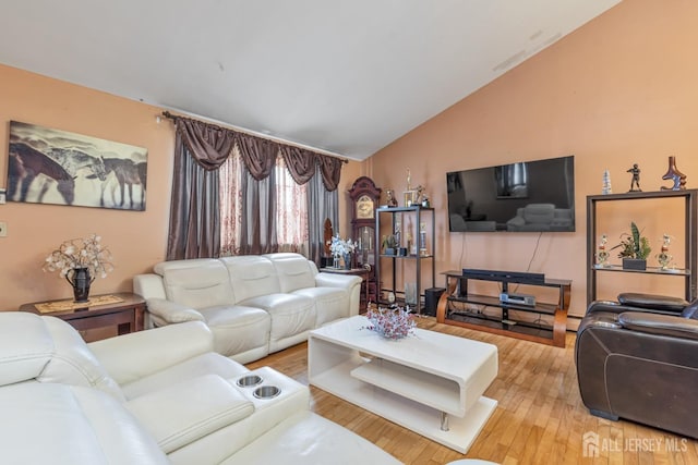 living room with lofted ceiling and hardwood / wood-style flooring