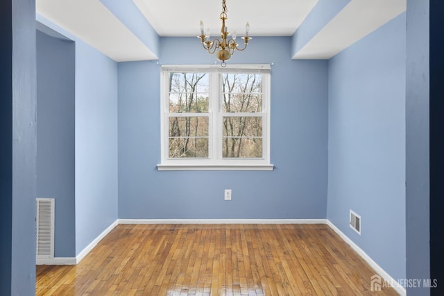 1724 Country Mill Dr, East Windsor, NJ 08512 - unfurnished dining area featuring a chandelier, wood-type flooring, and baseboards