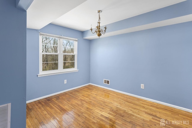 1724 Country Mill Dr, East Windsor, NJ 08512 - spare room with a chandelier, hardwood / wood-style floors, and baseboards