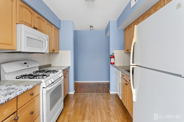 1724 Country Mill Dr, East Windsor, NJ 08512 - kitchen with white appliances, baseboards, light wood-style flooring, tasteful backsplash, and light stone counters